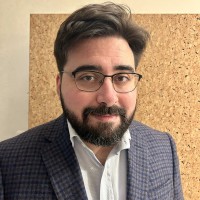 A picture of Dan, looking sharp and professional in a rarely-worn sports jacket.